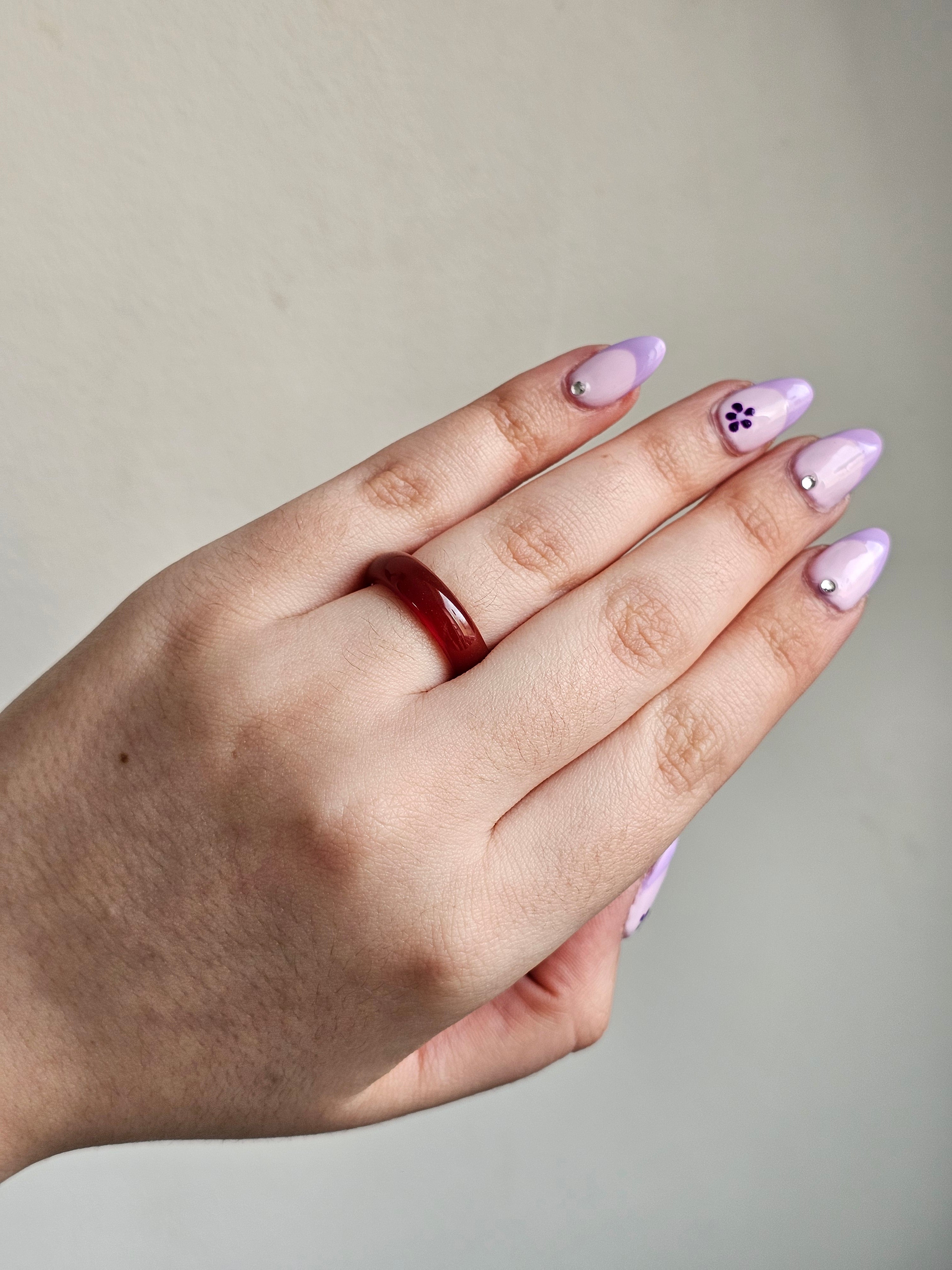 Carnelian banded ring being worn on a females hand 